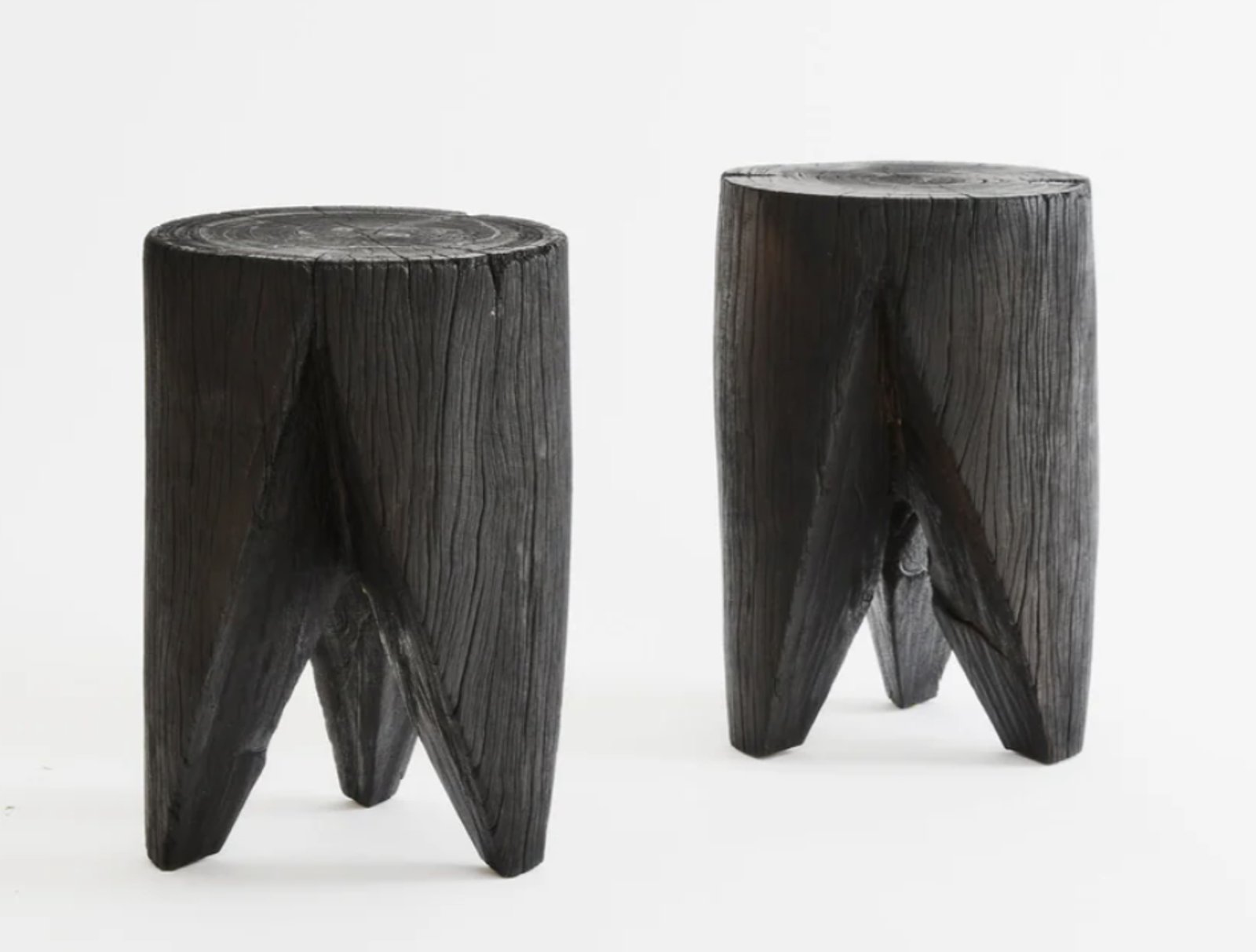 Almost zroe waste with decommissioned power poles repurposed as side tables that have a blackened finish by Five Mile Radius