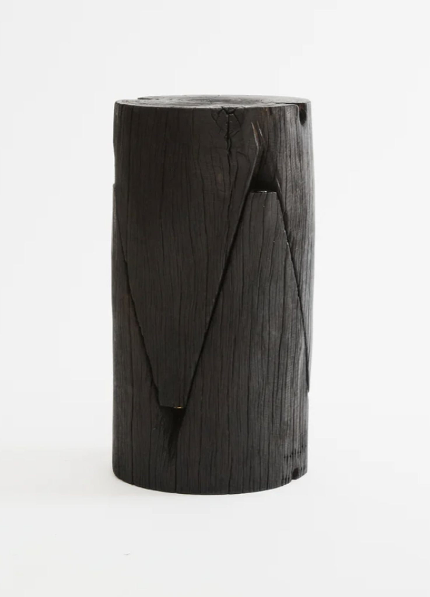Almost zroe waste with decommissioned power poles repurposed as side tables that have a blackened finish by Five Mile Radius